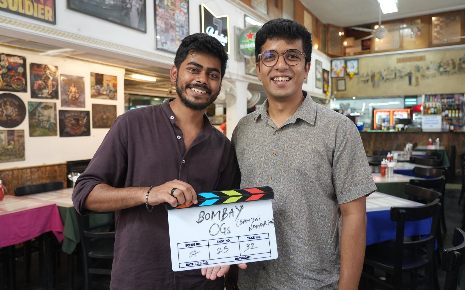 Ishan on set for The OGs, holding the clapboard